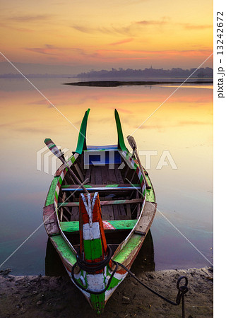 Wooden boat in Ubein Bridge at sunrise, Mandalay, Myanmar 13242672