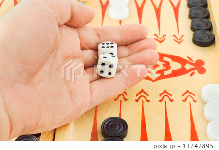 Hand with dices and backgammon 13242895