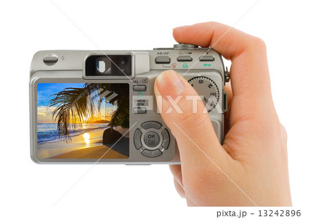 Hand with camera and beach landscape (my photo) 13242896