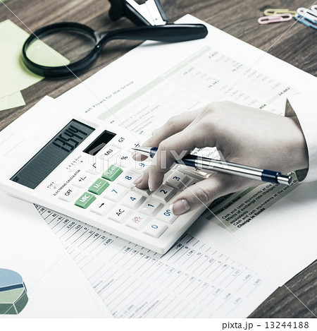Calculating on the office desk 13244188