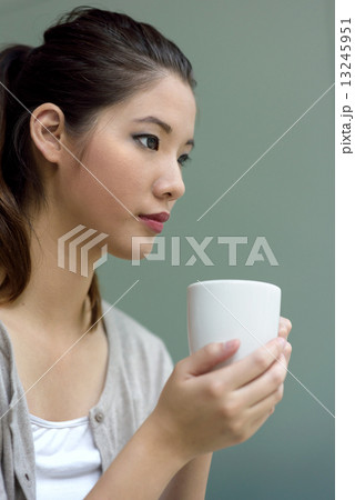 One young chinese woman holding a coffee cup 13245951