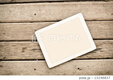 Tablet on wooden background. Tablet on wooden background. 13246837