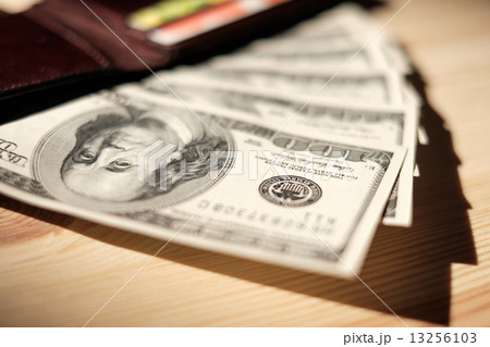 Brown Wallet with credit cards and dollar banknotes over wooden Brown Wallet with credit cards and dollar banknotes over wooden 13256103
