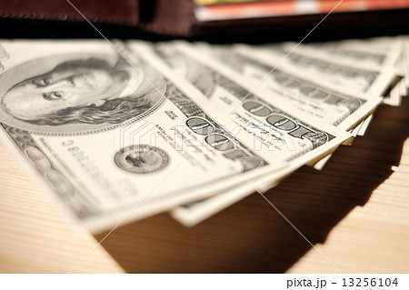 Brown Wallet with credit cards and dollar banknotes over wooden Brown Wallet with credit cards and dollar banknotes over wooden 13256104