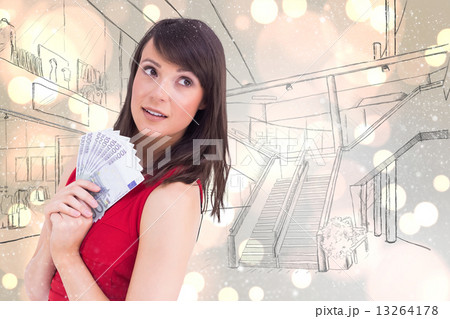 Composite image of festive brunette showing fan of dollars 13264178