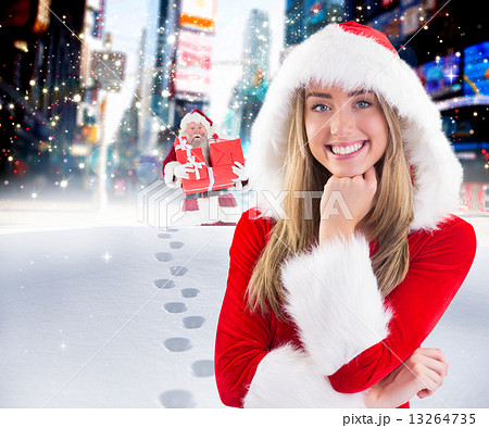 Composite image of pretty santa girl smiling at camera Composite image of pretty santa girl smiling at camera 13264735