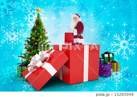 Composite image of santa standing in large gift Composite image of santa standing in large gift 13265049