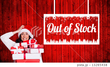 Composite image of shocked woman with christmas presents Composite image of shocked woman with christmas presents 13265438