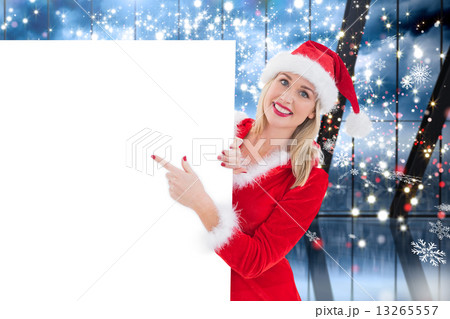 Composite image of festive blonde showing white card 13265557