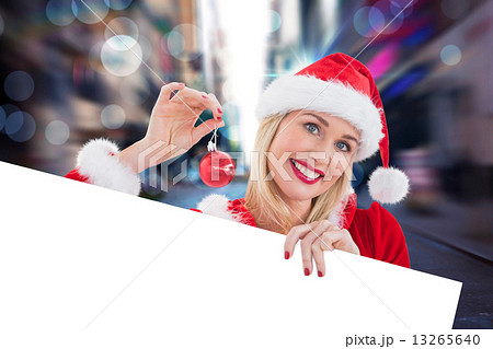 Composite image of festive blonde showing white card Composite image of festive blonde showing white card 13265640