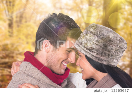 Composite image of young couple smiling and hugging 13265657