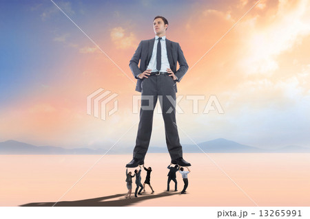 Composite image of business people supporting boss Composite image of business people supporting boss 13265991
