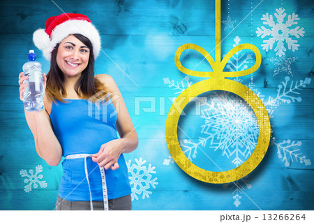 Festive fit brunette measuring her waist 13266264