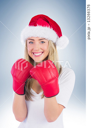 Festive blonde punching with boxing gloves 13266376