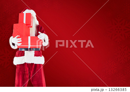 Composite image of santa covers his face with presents 13266385