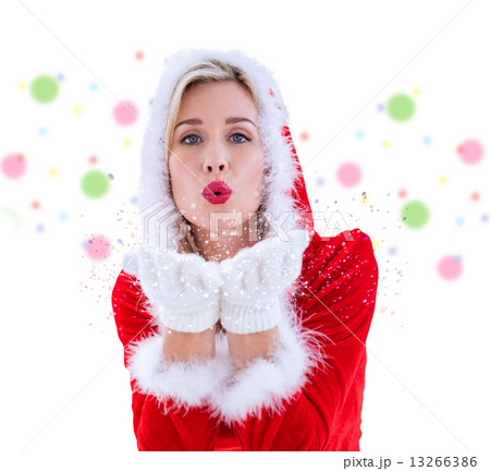 Composite image of festive blonde blowing a kiss Composite image of festive blonde blowing a kiss 13266386