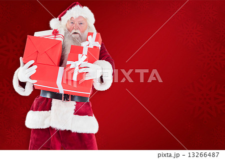 Composite image of santa carries a few presents 13266487