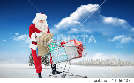 Composite image of santa delivering gifts with a trolley 13266488