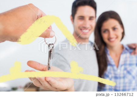Composite image of man being given a house key Composite image of man being given a house key 13266712