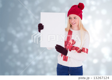 Composite image of festive blonde showing a blank page 13267124