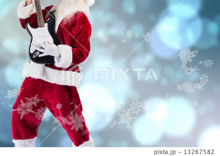 Composite image of santa playing electric guitar Composite image of santa playing electric guitar 13267582
