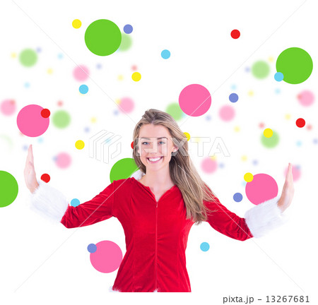 Composite image of pretty santa girl smiling at camera 13267681