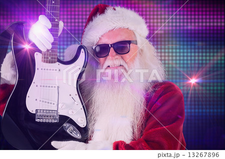 Composite image of father christmas shows a guitar Composite image of father christmas shows a guitar 13267896