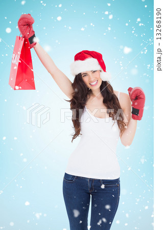 Composite image of festive brunette in boxing gloves with shoppi 13268190
