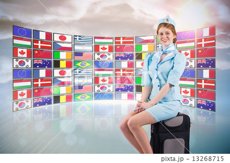 Composite image of pretty air hostess smiling at camera Composite image of pretty air hostess smiling at camera 13268715