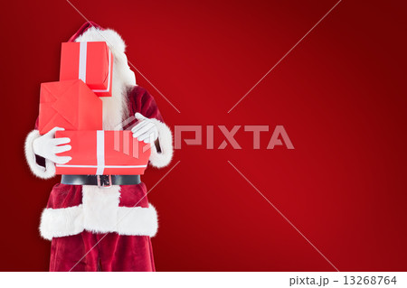 Composite image of santa covers his face with presents Composite image of santa covers his face with presents 13268764