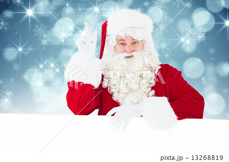 Composite image of smiling santa claus doing a gesture Composite image of smiling santa claus doing a gesture 13268819