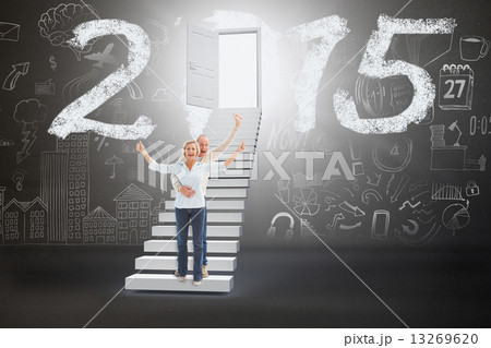 Composite image of happy mature couple cheering at camera 13269620