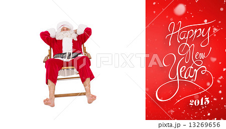 Composite image of happy santa relaxing on deckchair Composite image of happy santa relaxing on deckchair 13269656