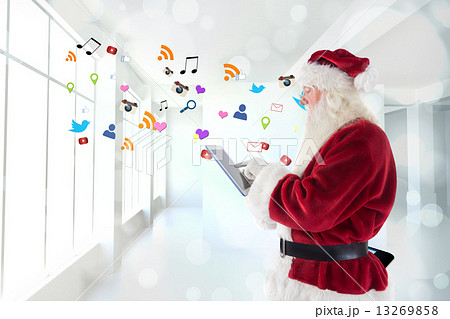 Composite image of santa uses a tablet pc 13269858