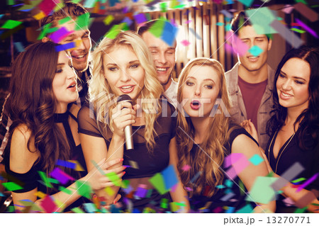Composite image of happy friends singing karaoke together Composite image of happy friends singing karaoke together 13270771