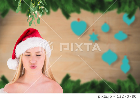 Composite image of festive cute blonde under mistletoe 13270780