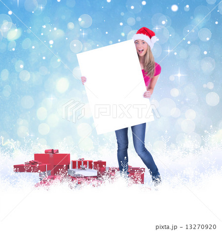 Festive blonde holding large poster Festive blonde holding large poster 13270920