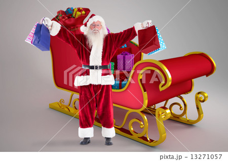 Composite image of santa holds some bags for chistmas Composite image of santa holds some bags for chistmas 13271057