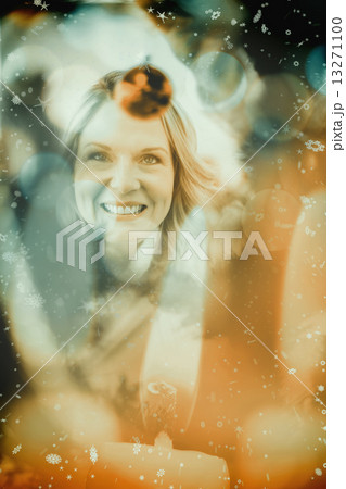Composite image of festive blonde hanging bauble on christmas tr Composite image of festive blonde hanging bauble on christmas tr 13271100