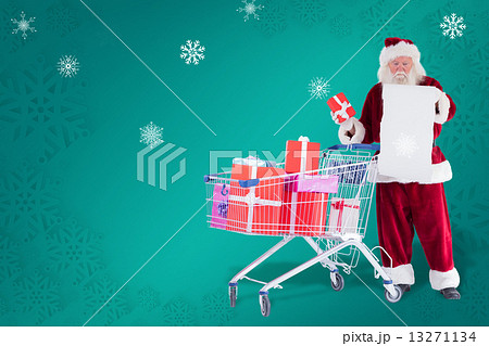Composite image of santa spread presents with shopping cart Composite image of santa spread presents with shopping cart 13271134