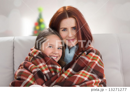 Composite image of mother and daughter under blanket 13271277