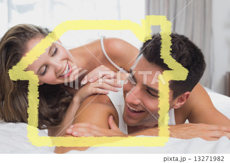 Composite image of romantic young couple in bed at home 13271982