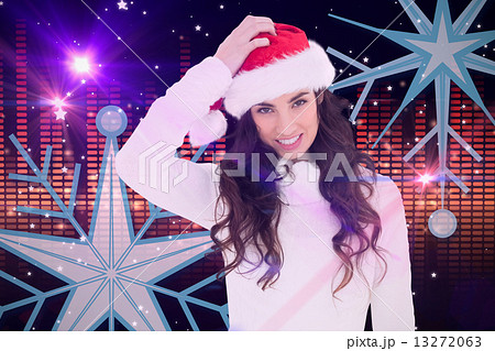 Composite image of confused brunette in santa hat 13272063
