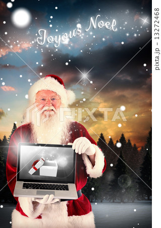 Composite image of santa claus presents a laptop Composite image of santa claus presents a laptop 13272468
