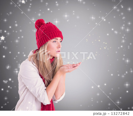 Composite image of happy blonde blowing over hands 13272842