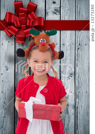 Composite image of cute little girl wearing rudolph headband Composite image of cute little girl wearing rudolph headband 13273260