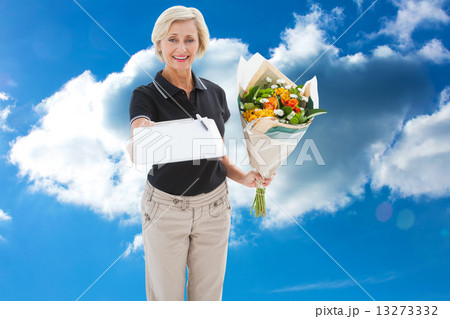 Composite image of happy flower delivery woman looking for signa Composite image of happy flower delivery woman looking for signa 13273332