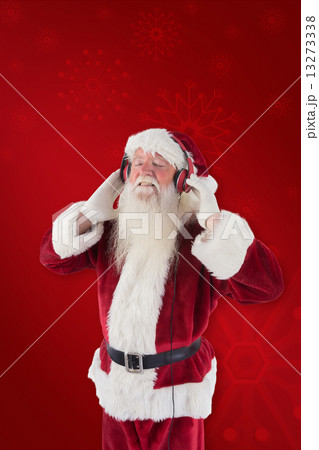 Composite image of santa claus enjoys some music 13273338