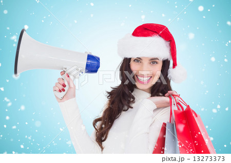 Composite image of smiling brunette holding gift bags and megaph Composite image of smiling brunette holding gift bags and megaph 13273373
