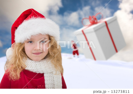 Composite image of cute girl in santa hat 13273811